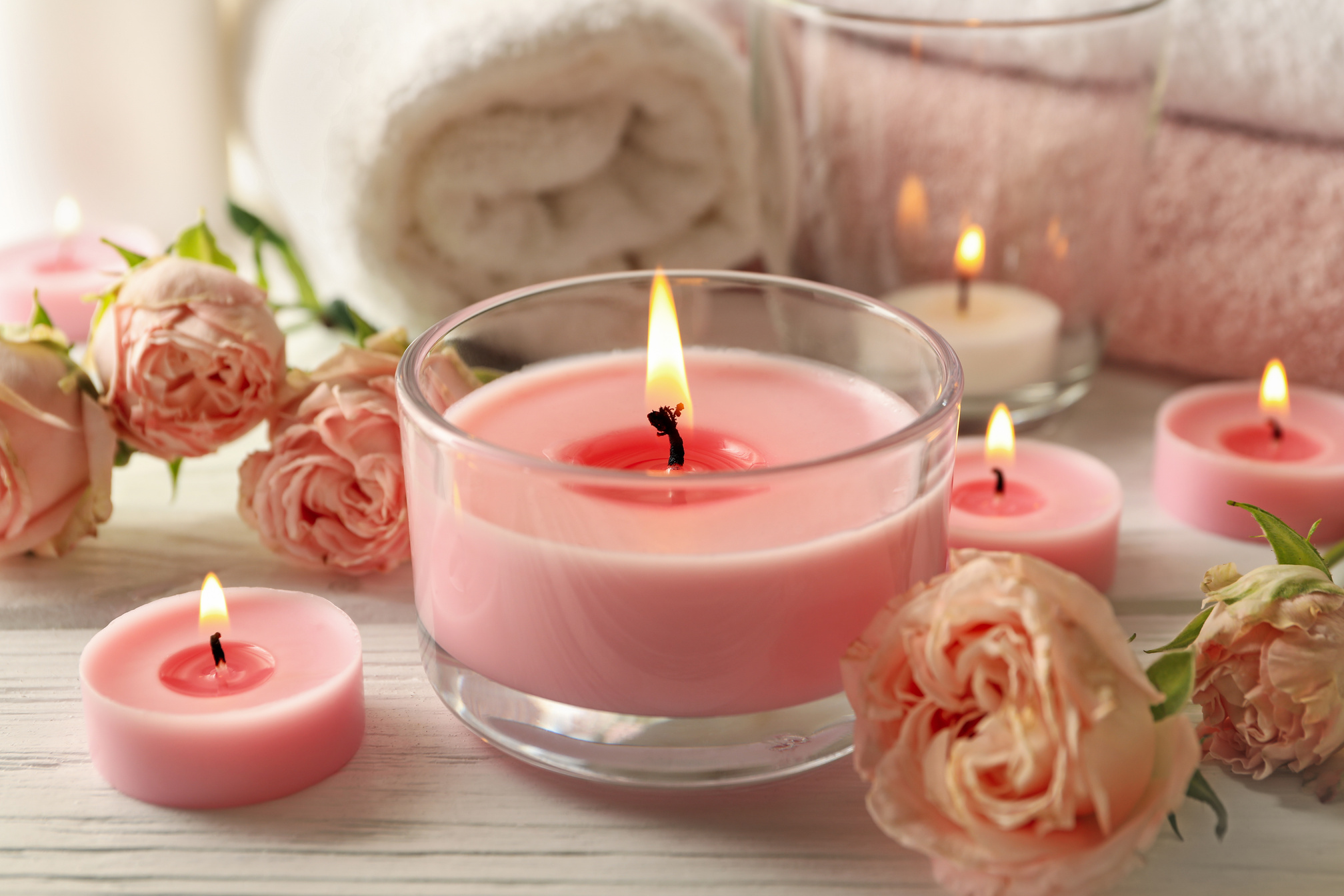 Pink Scented Candles on White Wooden Background